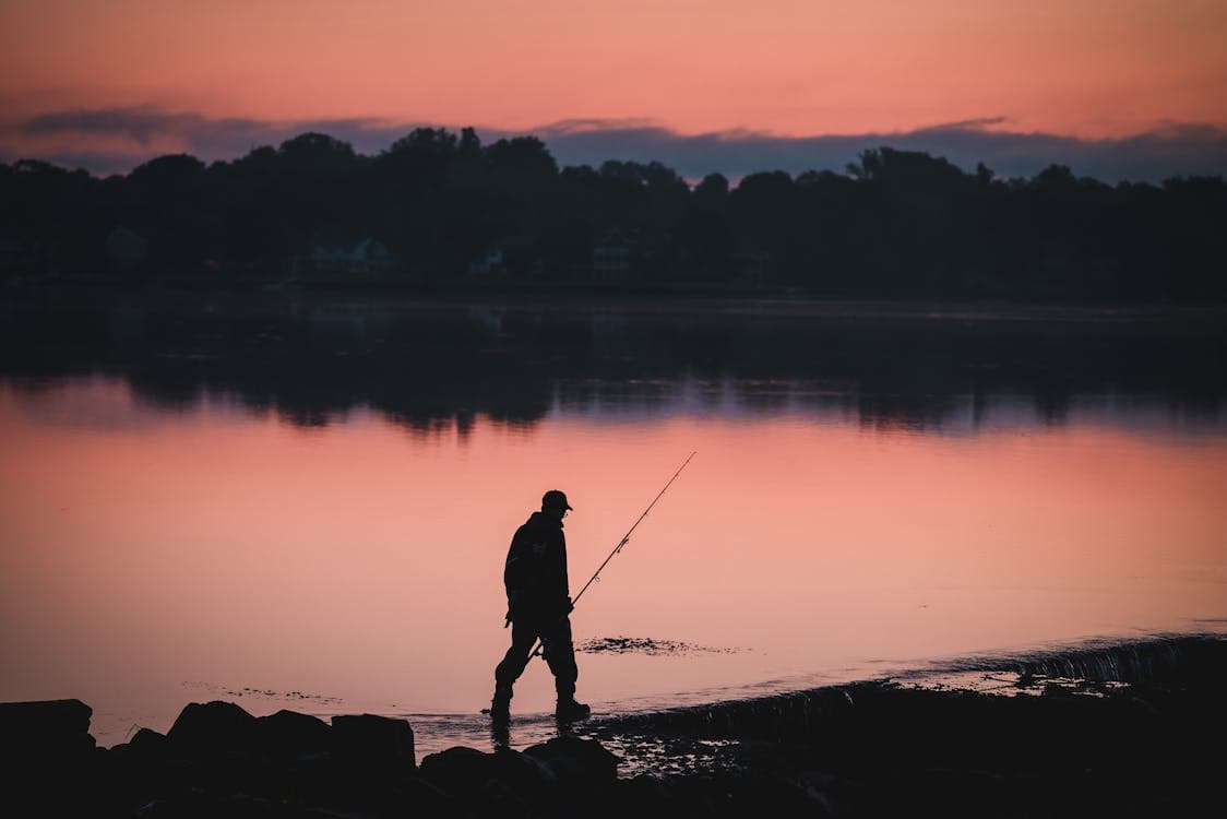Angler fishing at sunrise on a Mexican reservoir